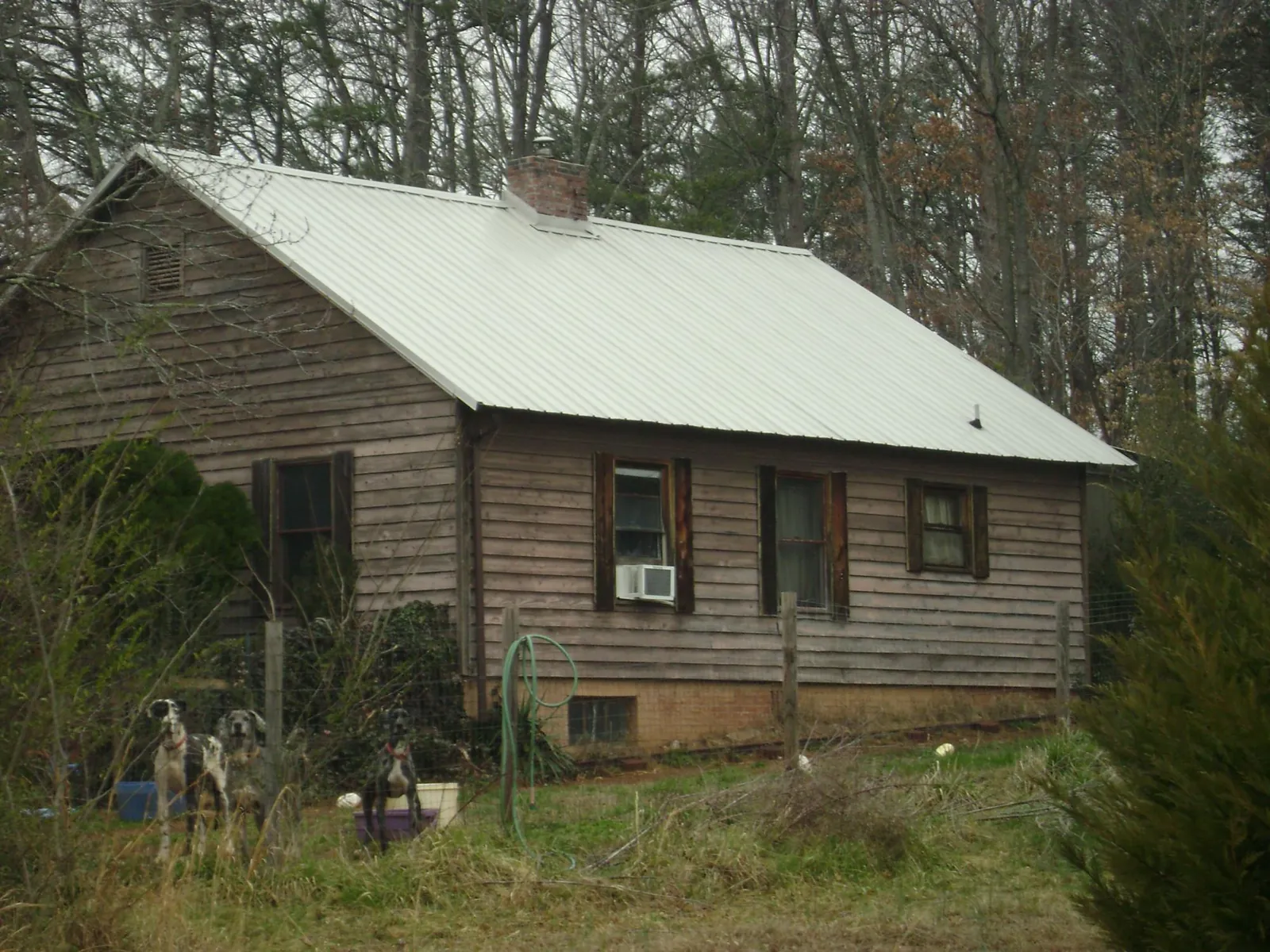 White metal roof on an old wood sided farmhouse, from a Metal Roof Installation job in Canby
